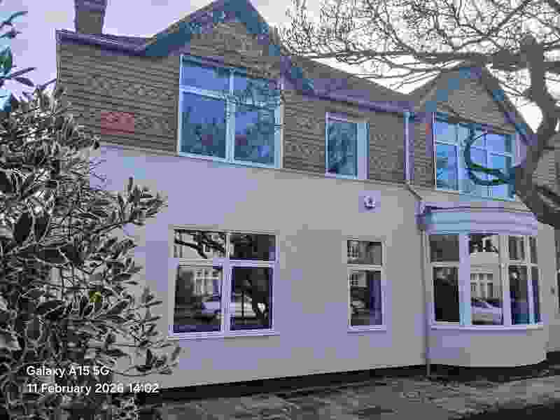 After — the front elevation wrapped in fresh external wall insulation and new windows