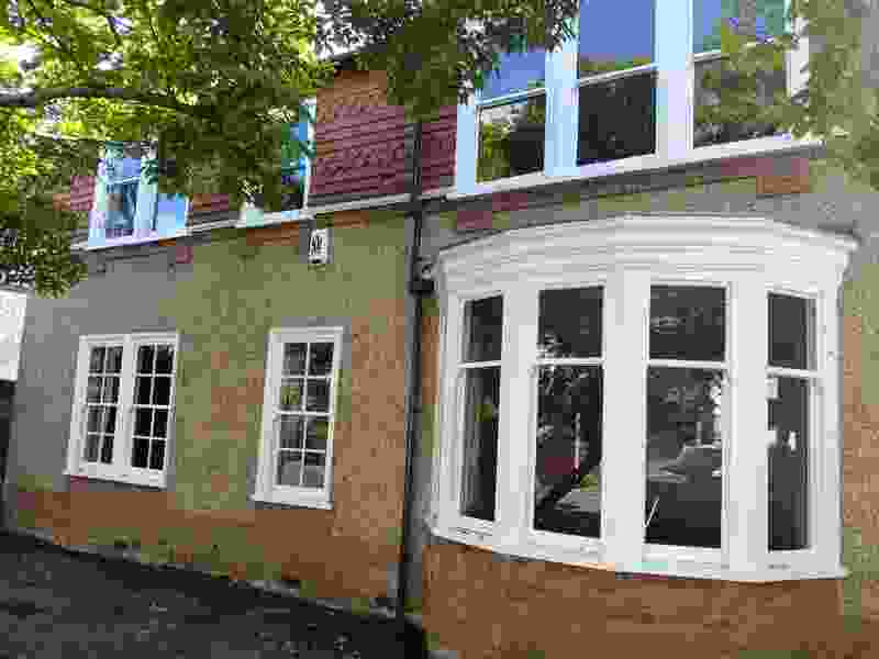 Before — tired render and draughty old windows on the front elevation
