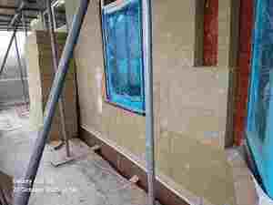During — the new insulation going up, ready for its render finish
